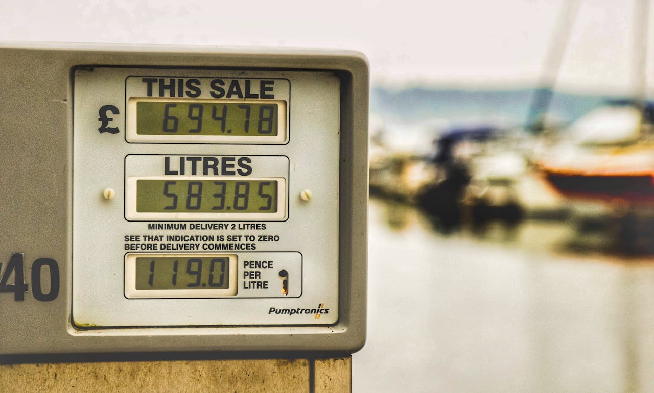 Blurred background view with focus on fuel pump display showing price and liters.